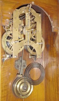 Ansonia Clock Co., New York, "Reflector" wall hanging clock with a spring driven 8 day time and strike (cathedral gong) movement in a walnut case.