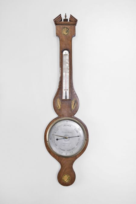 Vanini & Montini, Peterborough, England, wheel or banjo barometer with alcohol thermometer, in an inlaid mahogany veneered case with silvered dial and brass indicator knob.