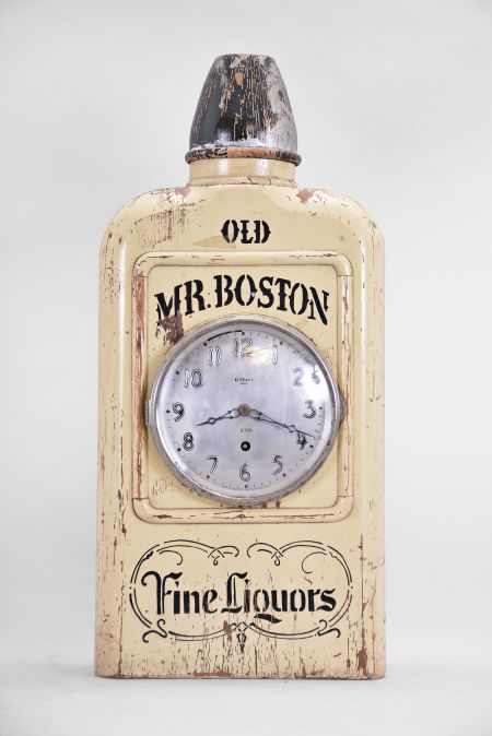 Wm. L. Gilbert Clock Co., Winsted, Conn., "Old Mr. Boston" novelty advertising clock, 8 day, time only, spring driven balance wheel movement in a solid wood case shaped and painted to look like a bottle of whisky, silvered dial and steel hands.