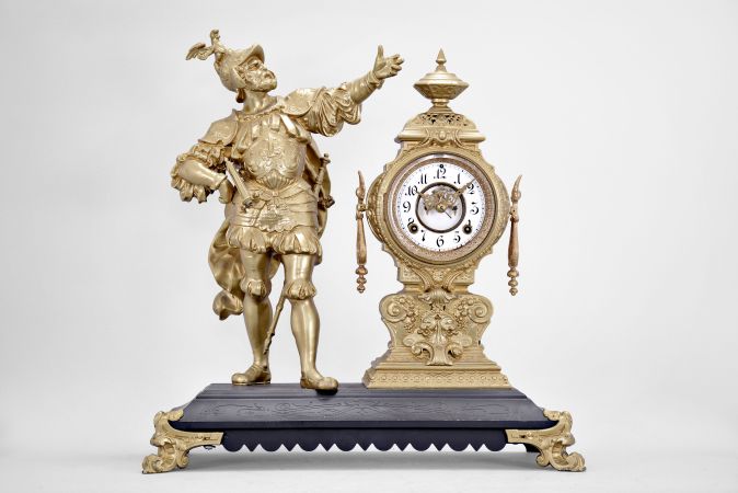 Ansonia Clock Co., New York, "Insult" figural mantel clock, 8 day, time and strike, spring driven movement with visible escapement, iron base on cast feet supporting the clock with white enamel dial and Louis XV style hands and a soldier figure with outstretched arm.