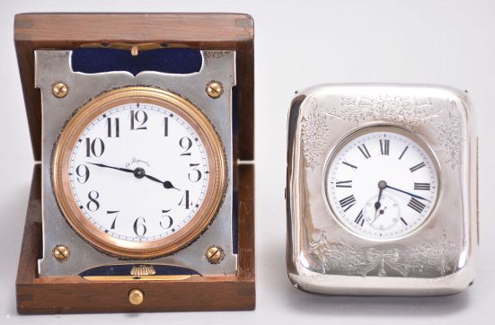 Travel clocks- 2 (Two): the first marked "Barbezat Swiss", 15 jewel, quarter repeating cotes de Geneve decorated nickel movement with arabic numeral white enamel dial, mounted to a folding sterling silver plate and hinged to a mahogany box, the top with applied foliate ornament surrounding a knight