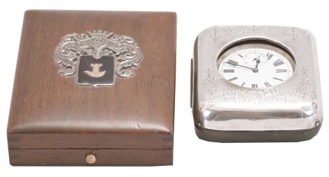 Travel clocks- 2 (Two): the first marked "Barbezat Swiss", 15 jewel, quarter repeating cotes de Geneve decorated nickel movement with arabic numeral white enamel dial, mounted to a folding sterling silver plate and hinged to a mahogany box, the top with applied foliate ornament surrounding a knight