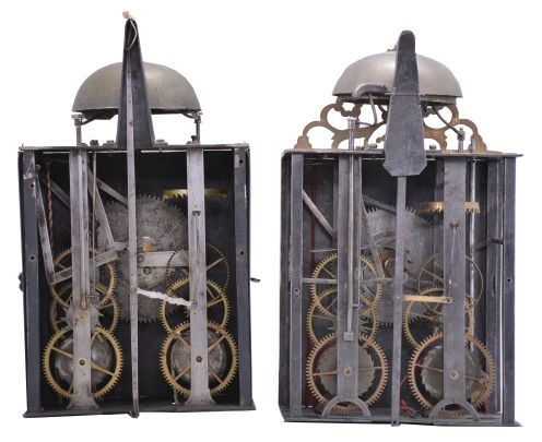 Clocks- 2 (Two) Early Comtoise: (1) France, Comtoise clock, 8 day, time and strike, weight driven movement with verge escapement, thread suspension with rear-hanging pendulum in a iron post and plate frame, brass chapter ring with engraved Roman numerals, pivoted winding arbor shutters, and single iron hand, first half of the 18th Century. (2) France, Comtoise clock, 8 day, time and strike with alarm sounding on a second bell, weight driven movement with verge escapement, thread suspension with rear-hanging pendulum in a iron post and plate frame, brass chapter ring with engraved Roman numerals, applied brass spandrels and pivoted winding arbor shutters, and single brass hand, first half of the 18th Century.