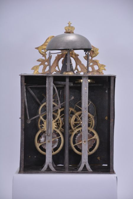 France, Comtoise wall clock, 8 day, time and strike, weight driven movement with verge escapement, thread suspension with front-hanging pendulum in an iron post and plate case with white enamel convex Roman numeral arcaded dial with Arabic minutes, polychrome floral decoration above the 6 o