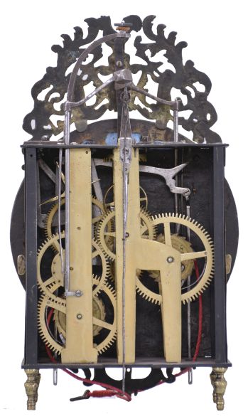 France, Comtoise lantern clock, 8 day, time and strike, weight driven condensed movement with verge escapement, wire suspension with rear-hanging pendulum in an iron posted case with hammered brass doors, cast brass dial with inset white enamel cartouches with blue Roman numerals, brass outer ring with Arabic numerals every 5 minutes, two steel hands, topped by cast bronze fronton featuring trumpeters and a forward facing Gallic rooster, all sitting on four turned brass feet.