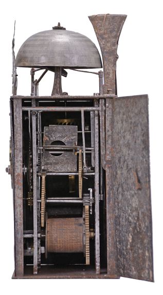 France, Comtoise clock, 8 day, time and strike with alarm, weight driven movement with verge escapement, thread suspension with rear-hanging pendulum in a iron post and plate frame, brass chapter ring with engraved Roman numerals, alarm dial with Arabic numerals, single brass hand, applied brass spandrels and pivoted winding arbor shutters, topped by flat pierced brass fronton with trademark.