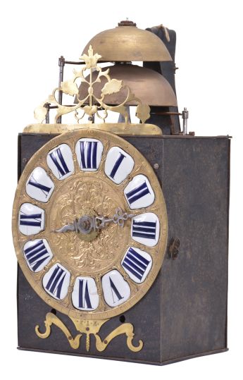 France, Comtoise clock, 8 day, time and strike with alarm, weight driven movement with verge escapement, thread suspension with rear-hanging pendulum in an iron post and plate frame, cast brass dial signed "P I M" with inset white enamel cartouches with blue Roman numerals, alarm ring with Arabic numerals, single iron hand, topped by a pierced brass fronton.