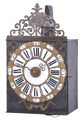 France, month-running Comtoise clock, 30 day, time and strike with alarm, weight driven movement, verge escapement with thread suspension and rear-hanging pendulum in an iron post and plate frame, cast brass dial with inset white enamel cartouche numerals with blue Roman numerals, outer ring with Arabic numerals every five minutes, brass alarm ring with Arabic numerals, two brass hands, applied brass spandrels and pivoted winding arbor shutters, all topped by a pierced brass fronton.