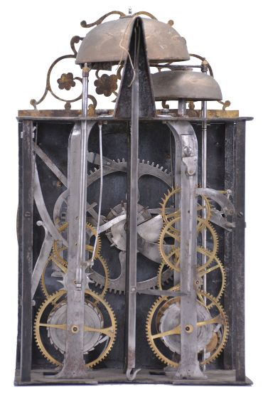 France, Comtoise clock, 8 day, time and strike with alarm, weight driven movement with rare Maillet (or Mayet) escapement and unusual double vertical rack strike in a posted iron frame, cast brass dial with profile of young Louis XV with inset white enamel cartouches with blue Roman numerals, alarm ring with Arabic numerals, single pierced iron hand, brass spandrels above and pivoted winding arbor shutters below, all topped with a pierced brass fronton with floral motif.