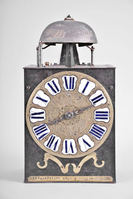 Jean Baptiste Baud, Bellefontaine, France, Comtoise clock, 8 day, time and strike with alarm, weight driven movement with verge escapement, thread suspension with rear-hanging pendulum in a iron post and plate frame, cast brass dial with birds, valances, and inset enamel cartouche numerals, brass alarm ring with Arabic numerals, single pierced iron hand, pivoted brass winding arbor shutters, and lower brass plaque signed "JEAN BAPTISTE BAUD A BELLE FONTAINE ".