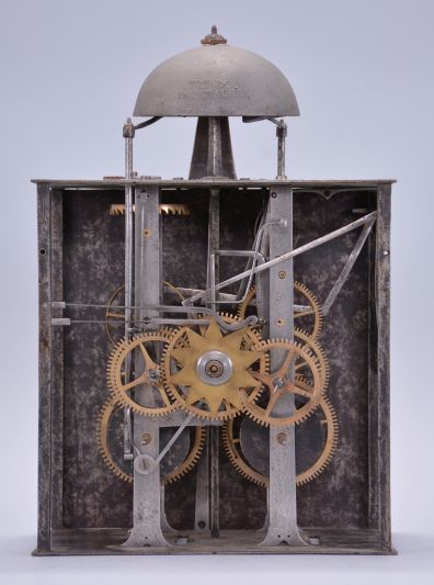 France, Revolutionary Era bronze-front Comtoise clock, 8 day, time and strike, day of the month and day of the week according to the French Republican Calendar, weight driven movement with verge escapement, thread suspension with rear-hanging pendulum in an iron post and plate frame, early enamel dial with concave center and convex chapter, Roman numerals for the hours, Arabic numerals for the minutes and days of the month, four iron hands, date hands embellished with Phrygian caps, cast bronze fronton with sun and lion motifs, lower cast fronton with medallion engraved with the date.