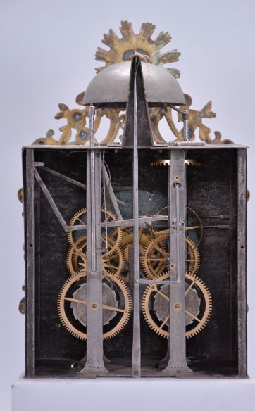 France, Revolutionary Era bronze-front Comtoise clock, 8 day, time and strike, day of the month and day of the week according to the French Republican Calendar, weight driven movement with verge escapement, thread suspension with rear-hanging pendulum in an iron post and plate frame, early enamel dial with concave center and convex chapter, Roman numerals for the hours, Arabic numerals for the minutes and days of the month, four iron hands, date hands embellished with Phrygian caps, cast bronze fronton with sun and lion motifs, lower cast fronton with medallion engraved with the date.