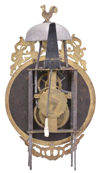 France, Comtoise lantern clock, 30 hour, time and strike, weight driven movement with rare pin wheel escapement, iron frame and feet, rear mounted thread suspension, cast brass dial with profile of Louis XV and inset with 12 white enamel cartouches with Roman numerals, outer ring with Arabic numerals every 5 minutes, cast bronze fronton with trumpeters flanking a medallion topped by the Gallic rooster, two iron hands.