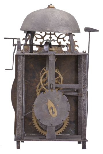 France, lantern clock, 30 hour, time and strike, weight driven movement, verge escapement with upward facing crown wheel, thread suspension with side-mounted pendulum, posted iron frame resting on short iron feet, brass front with integrated dial showing Roman numerals, single iron hand, topped by bell and pierced brass fronton.