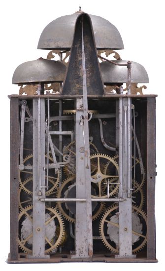 France, bronze-front Comtoise clock, 8 day, time and quarter strike with alarm, three bells, weight driven movement with verge escapement, thread suspension with rear-hanging pendulum in an iron post and plate frame, cast brass dial inset with 12 white enamel cartouches showing Roman numerals, Arabic numerals at 5 minute intervals on the outer rim, brass alarm ring with Arabic numerals, two iron hands, pivoted brass winding arbor shutters engraved with "A" and "M", all topped by cast fronton depicting trumpeters flanking a small forward facing Gallic rooster.