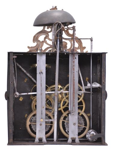 France, Louis XV Comtoise clock, 8 day, time and strike with alarm, weight driven movement with verge escapement, thread suspension with rear-hanging pendulum, iron post and plate frame, dial composed of 13 enamel panels with Roman and Arabic numerals, brass alarm ring with Arabic numerals, two pierced brass hands, cast brass spandrels below the dial with putti supporting crowns, all topped by a cast brass fronton with sun emblem within a rococo design.