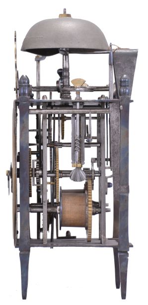 France, Comtoise lantern clock, 8 day, time and strike with alarm, weight driven movement with Chevalier de Béthune escapement, thread suspension with rear-hanging pendulum in a iron posted iron frame, brass chapter ring with engraved Roman numerals, brass alarm ring with engraved Arabic numerals, two iron hands, all surmounted by a cast brass fronton and four turned iron finials.