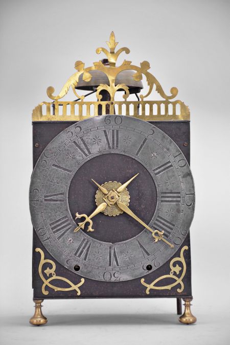 France, oversized Comtoise lantern clock, month running, time and strike with alarm, weight driven movement with verge escapement, rear-mounted thread suspension in a iron post and plate frame with turned brass feet in the front, pewter chapter ring with Roman numerals for the hours, outer ring with Arabic numerals every 5 minutes, brass alarm ring with Arabic numerals, pierced flat brass fronton and lower spandrels, and two brass hands.