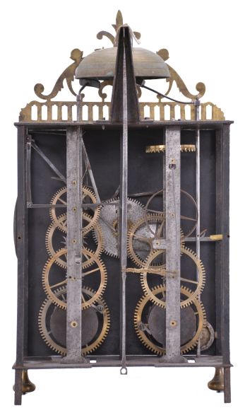 France, oversized Comtoise lantern clock, month running, time and strike with alarm, weight driven movement with verge escapement, rear-mounted thread suspension in a iron post and plate frame with turned brass feet in the front, pewter chapter ring with Roman numerals for the hours, outer ring with Arabic numerals every 5 minutes, brass alarm ring with Arabic numerals, pierced flat brass fronton and lower spandrels, and two brass hands.