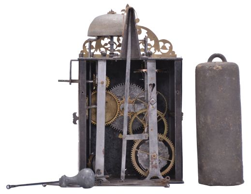 Brocard, Comté, France, Comtoise clock, 8 day, time and alarm, weight driven movement with verge escapement, thread suspension with rear-hanging pendulum in a iron post and plate frame, brass chapter ring with engraved Roman numerals, brass alarm ring with engraved Arabic numerals, flat brass fleur de lis spandrels and pivoted winding arbor shutters, engraved plaque below the dial reading "Brocard en Comté", single pierced brass hand, all topped with a pierced brass fronton.