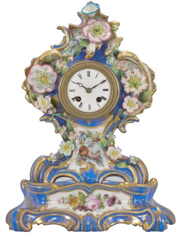 France, two-part porcelain mantel clock, 8 day, time and strike, pendule de Paris movement with silk thread suspension, the case in the style of Jacob Petit, decorated with molded and brightly painted naturalistic ornament, blue ground highlighted by bright gilding, white enamel dial with Roman numerals, Breguet style steel hands, all resting on a wood base under a glass dome