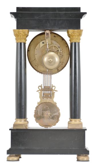 France, Empire portico clock, 8 day, time and strike, spring driven pendule de Paris movement in a polished black slate case on cast brass feet, the base and top with applied gilt rose ornaments, four Corinthian columns with gilt bases and capitals, the gilt bezel with repeating acanthus leaf design, gilt chapter ring with Roman numerals, cast dial center and gridiron pendulum both with floral designs, blued steel Breguet hands.